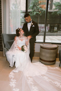 Groom dipping the bride into a kiss beside a window