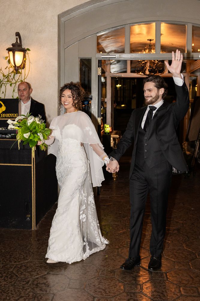 The couple enter the reception hand in hand to applause from the guests