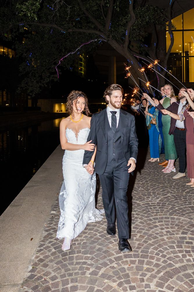 The couple walk out through a sparkler send-off at the end of the night