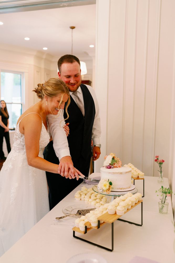 Bride and groom cutting their wedding cake together