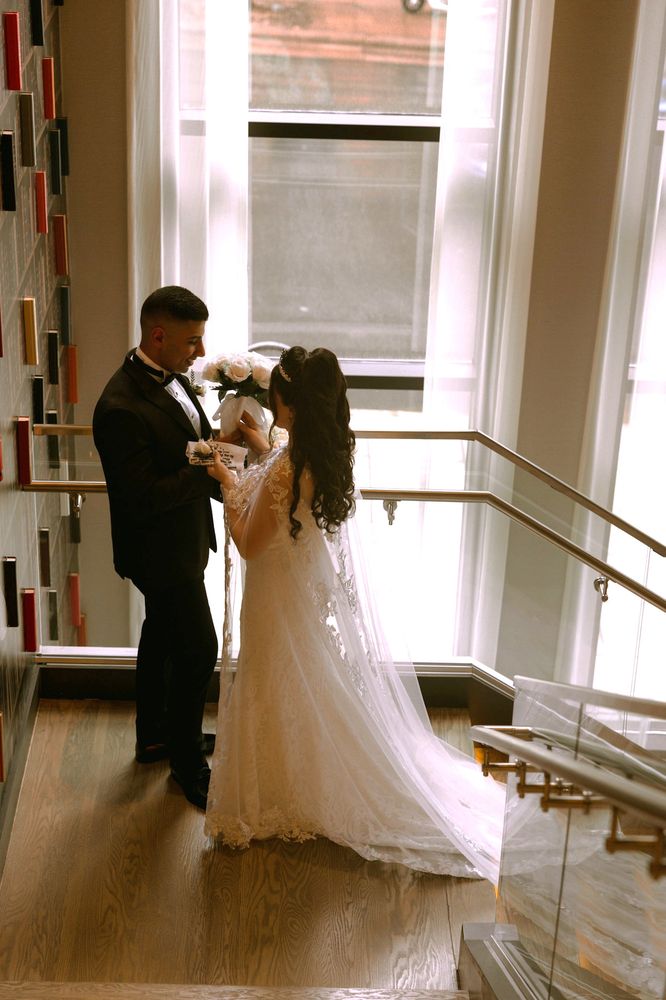 Bride and groom on a staircase in soft daylight