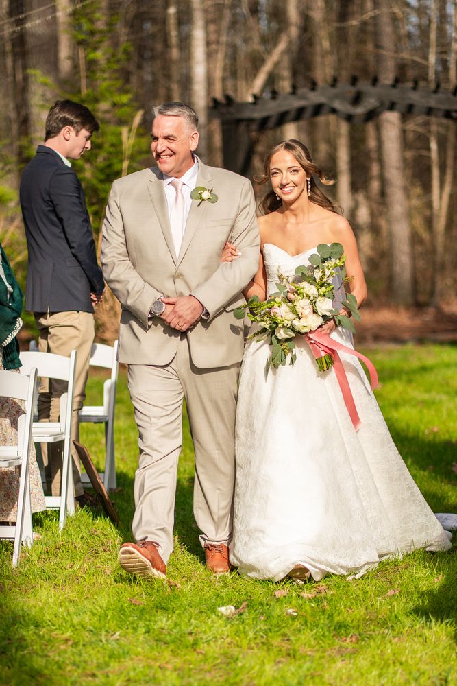 The bride walking down the aisle on her father's arm