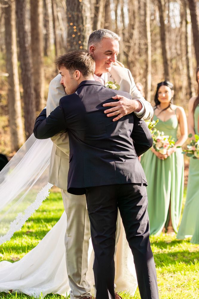 The bride embracing her father at the end of the aisle
